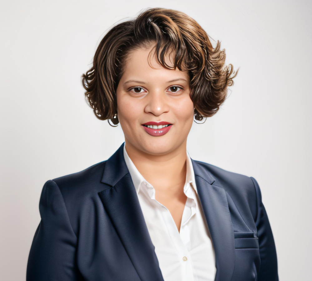 Professional headshot of Desiree Horsey in a navy blazer and white shirt, smiling confidently.